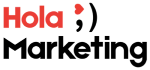Logotipo Hola Marketing. Hola escrito con tipografía Roja Un emoji de un guiño de ojos en el que el ojo abierto es un corazón y la palabra Marketing abajo en negro